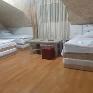 a living room with two beds and a table at Noy in Goris