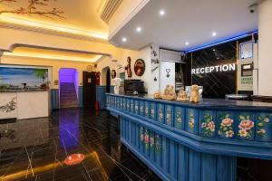 a bar in a restaurant with a blue counter at Dublin Hotel in Alanya