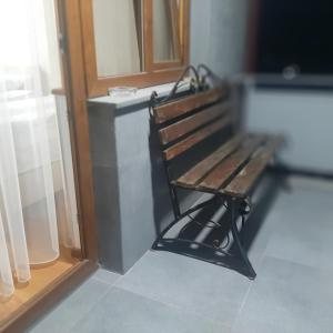 a wooden bench sitting in front of a door at Noy in Goris +9 photos