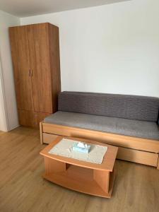 a bed in a room with a coffee table at Stylish New Apartment with Parking Place in Bratislava