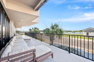 a balcony with benches and a view of the ocean at Bask Hotel at Big Rock Landing in Morehead City