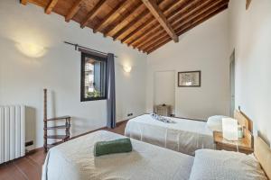 a room with two beds and a window at I Balconi in Iseo