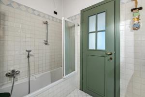 a bathroom with a shower and a green door at I Balconi in Iseo +24 photos