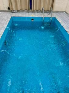 a swimming pool with blue water at شاليهات زارا 2 in Taif +7 photos