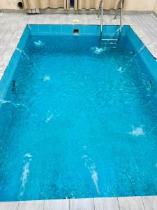 a swimming pool with blue water in it at شاليهات زارا 2 in Taif