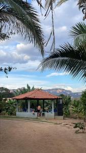 a gazebo with a person standing in it at Pousada Do Goiano in Manhã