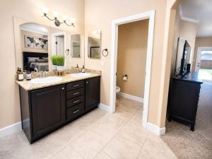 a bathroom with two sinks and a large mirror at The Palo Pinto in Alamogordo +28 photos