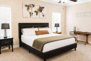 a bedroom with a large bed and a desk at The Palo Pinto in Alamogordo