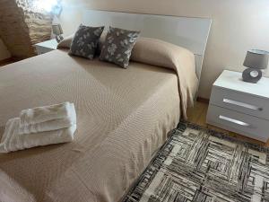 a bedroom with a large bed with pillows and a rug at Imperial House in Poggio Imperiale