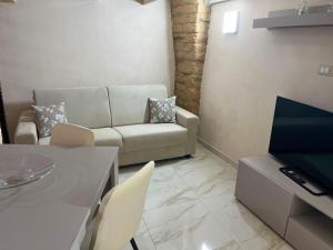 a living room with a couch and a table at Imperial House in Poggio Imperiale