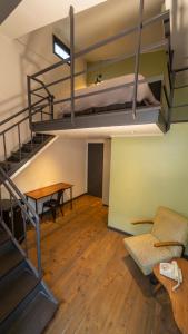 a room with a bunk bed and a table at La Joya Hostel in Valparaíso