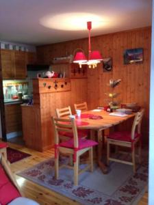 a kitchen with a wooden table with chairs and a dining room at Family mountain retreat with breathtaking views in Le Monêtier-les-Bains +4 photos