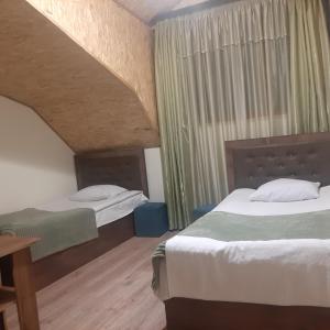 a hotel room with two beds and a table at Hotel Noy in Goris +43 photos