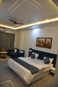 a bedroom with a large bed and a couch at Hotel Ramayana in Ellora