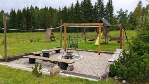 a playground with a bench and a swing at Chata Krusznia in Giby