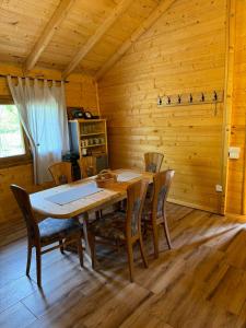a wooden dining room with a wooden table and chairs at Brvnara Dina in Železnička Stanica Dolovo