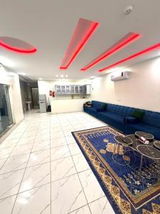 a living room with a blue couch and a rug at شاليهات زارا Zare in Taif