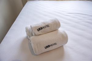 two towels sitting on top of a bed at URB Hotel in Fortaleza +51 photos