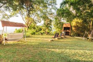 a park with a tent and signs in the grass at Cozy Apartment in Minca in Minca