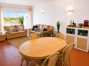 a living room with a wooden table and chairs at Bela Ria Waterfront House Pool & Boat to Beach in Cabanas de Tavira +27 photos
