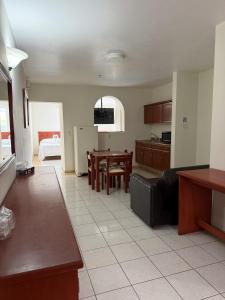 a kitchen and living room with a couch and a table at Hotel NV in Guadalajara