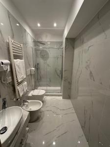 a bathroom with a shower and a sink and a toilet at Hotel Corona in Termoli