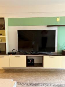 a large entertainment center with a large flat screen tv at Vila Srna in Petrovac na Moru
