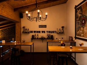 a dining room with two tables and a chandelier at Kalken Hotel by MH in El Calafate