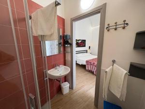 a bathroom with a sink and a mirror at Struttura Le Gemme in Marettimo