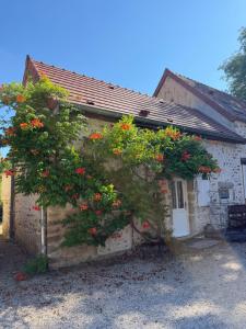 a house with a flowering tree in front of it at Domaine Les Bertrands in Couches +11 photos