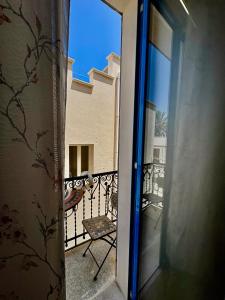 an open door to a balcony with a chair at Struttura Le Gemme in Marettimo