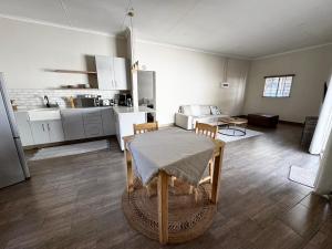 a living room with a table and a kitchen at Family Garden Suite - Sleeps 4 in Pretoria