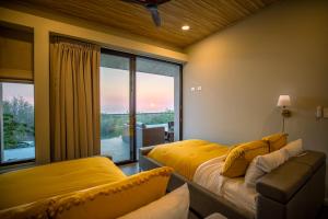 a bedroom with two beds and a large window at Ocean View Villa at Solindo Stays in Marbella +25 photos