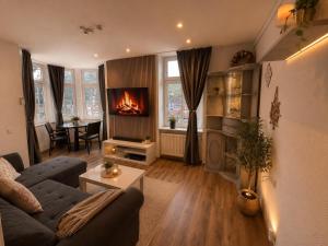 a living room with a couch and a fireplace at Kurvilla Hotel & Apartment in Landstuhl