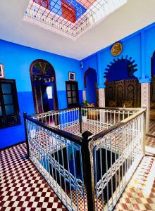 a room with blue walls and a checkered floor at Hostel Znika Chefchaouen in Chefchaouen