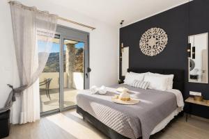 a bedroom with a large bed and a balcony at Villa Livis 1 in Kiotari