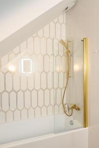 a shower in a bathroom with white tile at Velur Haus in Borne Sulinowo +58 photos