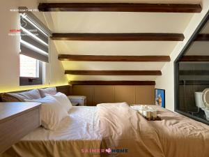 a bedroom with a large bed with white sheets at Saimer Home in Tân Thành (1)