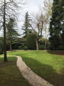 a gravel path in a park with trees and grass at Caserio Arrigorri in Murguía