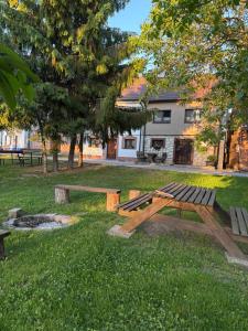 a picnic table and bench in a park at Sklípek Glosovi in Hovorany