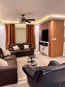 a living room with a couch and a tv at Victory House Mty in Monterrey