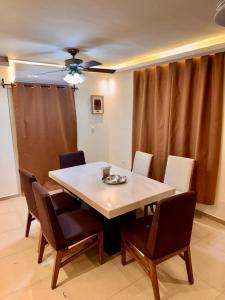 a dining room table with chairs and a ceiling fan at Victory House Mty in Monterrey