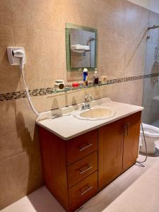 a bathroom with a sink and a shower at Victory House Mty in Monterrey +13 photos