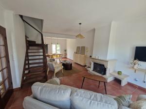 ein Wohnzimmer mit Sofa und Kamin in der Unterkunft CasaSoldoré in Sesimbra