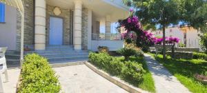 a house with purple flowers on the front yard at Grillo Superior Apartments - Enjoy Your Life! in Capo Vaticano +113 photos
