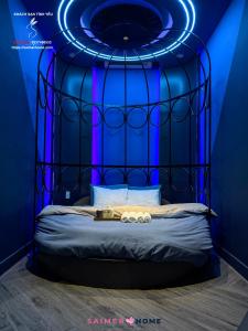 a blue room with a bed with a blue ceiling at Saimer Home in Tân Thành (1)
