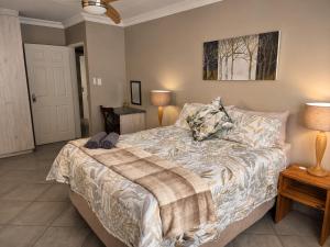 a bedroom with a bed and two lamps at Galago Rest in Leeupoort
