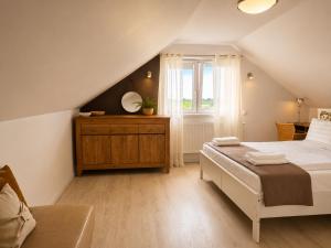 a bedroom with a large bed and a window at Widokówka in Tarnobrzeg