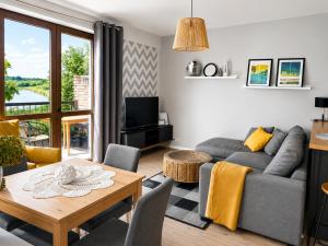 a living room with a couch and a table at Widokówka in Tarnobrzeg