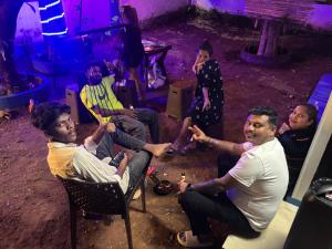 a group of people sitting in chairs in a room at Bela Blue Stays in Bardez